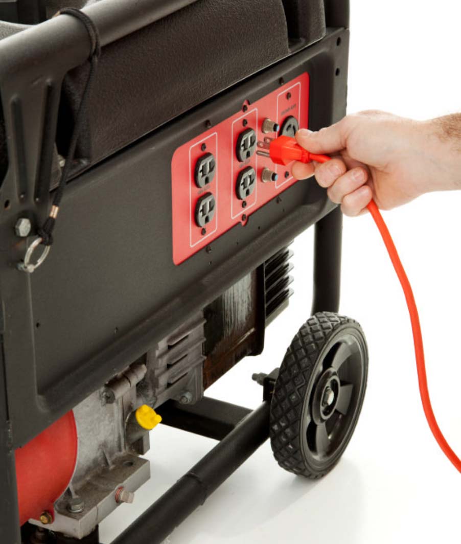 Hand plugging in cord to generator